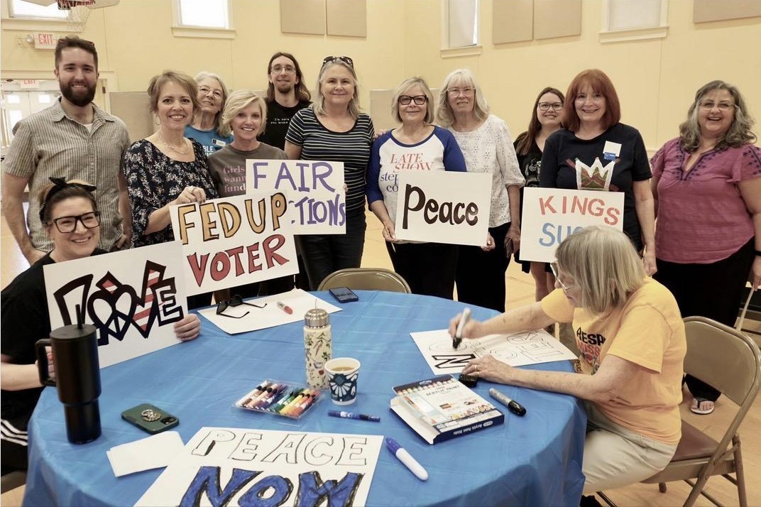 Cathy Summers (second from left) with Indivisible St. Louis volunteers making protest signs